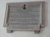 The memorial plaque to Lt Cmd E C Cookson VC on the South wall of the nave of the church of St Candida and Holy Cross Whitchurch Canonicorum