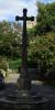 A general view of the Cross of Remembrance with the Church of St Candida Whitchurch Canonicorum in the background