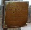 A close view of the brass plaque on the cross