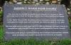A close view of the metal commemorative plaque on Hamble foreshore