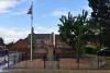 Full frontal view including railed area and flag