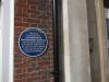Plaque attached to Academy's wall, commemorating site of former Memorial Hospital