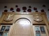 The top section of the board showing photographs of the fallen, behind doors.