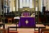 The names panels may be seen behind the screen; the dedication is on the pillars to the left and right of the altar