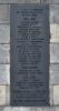 Close up of a metal plaque inscription in black lettering.