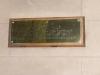 Brass plaque on wooden back board