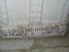 Close up of part of the inscription at the bottom of a stone baptismal basin.