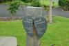 The broken plaque beside the statue