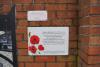 The interpretative plaques to the right of the mosaic on the outside wall of the flats' site